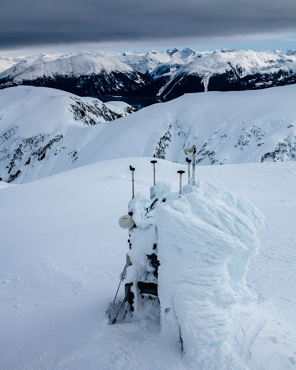 Mountain Weather API machinery covered in heavy snow in the mountains.